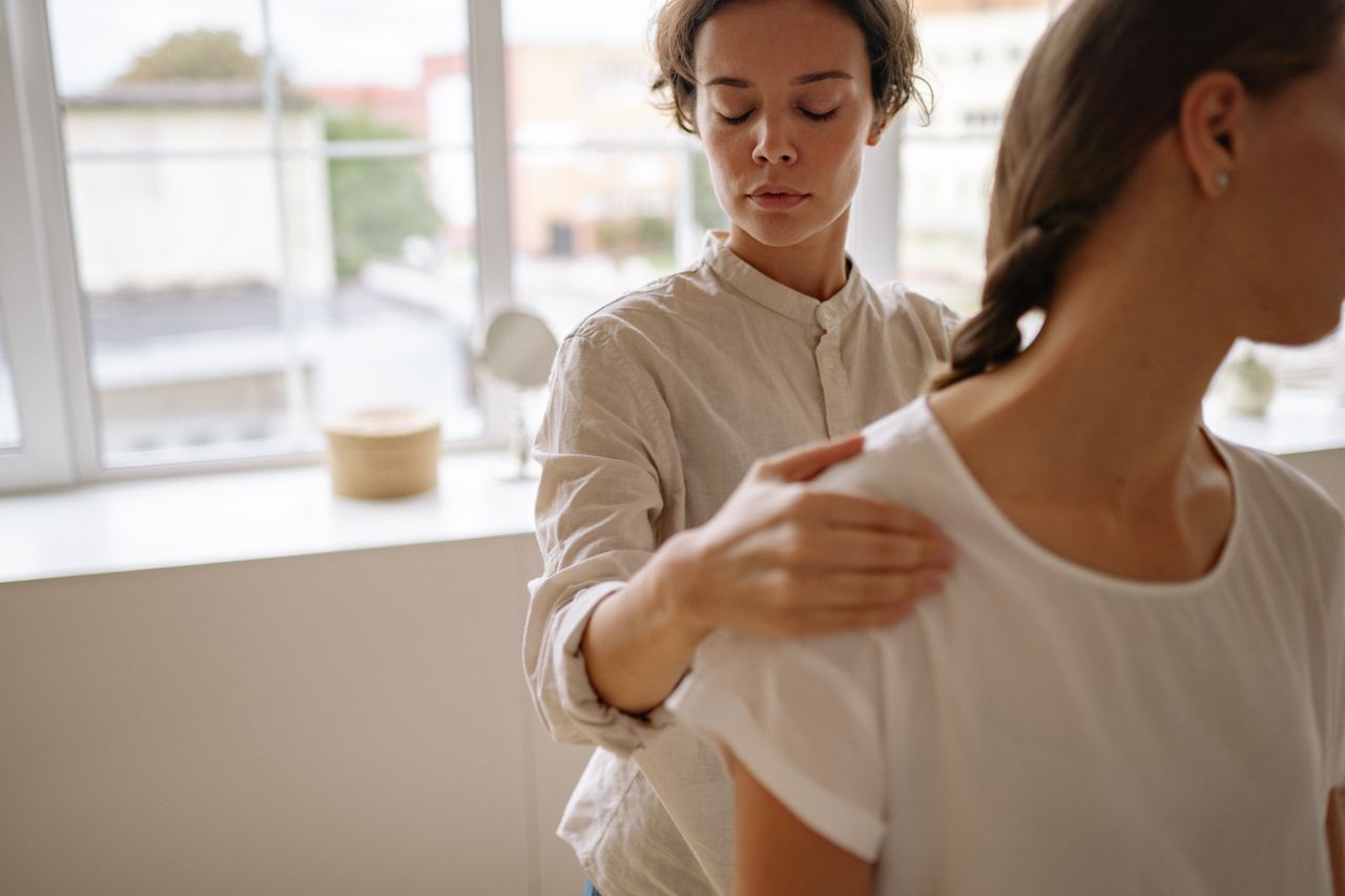 Services A physiotherapist provides treatment to a client in a bright, modern clinic setting.